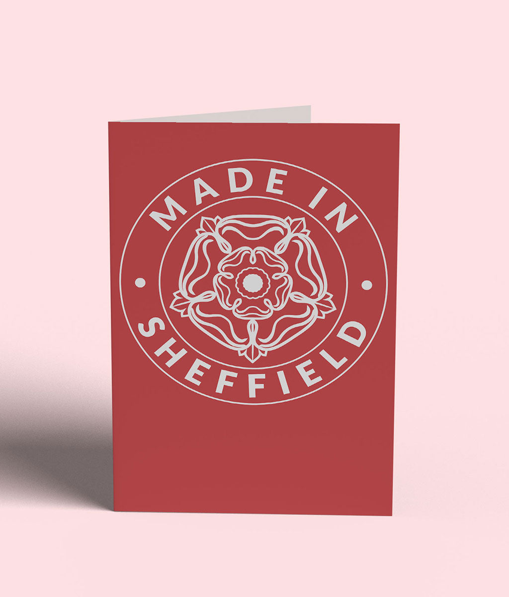 Red card with 'Made in Sheffield' text and emblem on a pink background