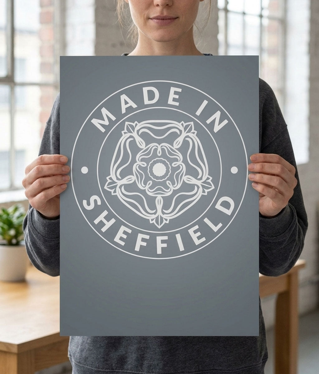 Person holding a 'Made in Sheffield' poster with a Yorkshire Rose emblem.
