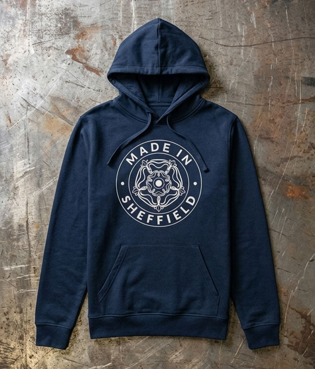 Navy blue hoodie with 'Made in Sheffield' logo on a textured metal surface