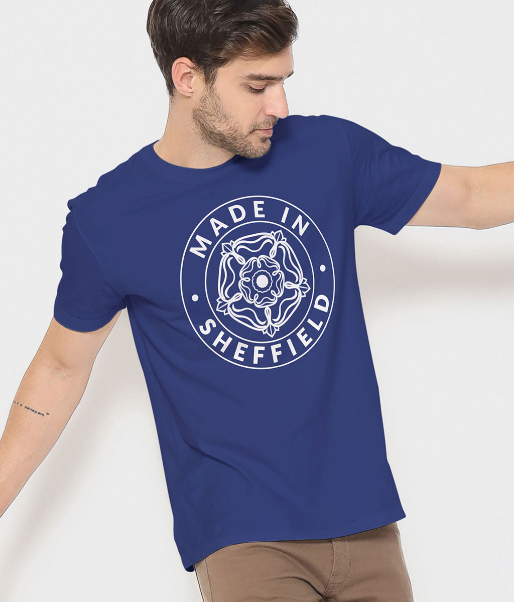 Person wearing a blue t-shirt with 'Made in Sheffield' design on a white background