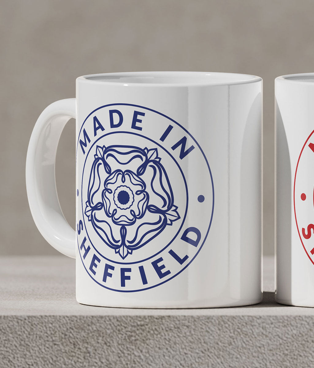 White mug with 'Made in Sheffield' design on a gray surface