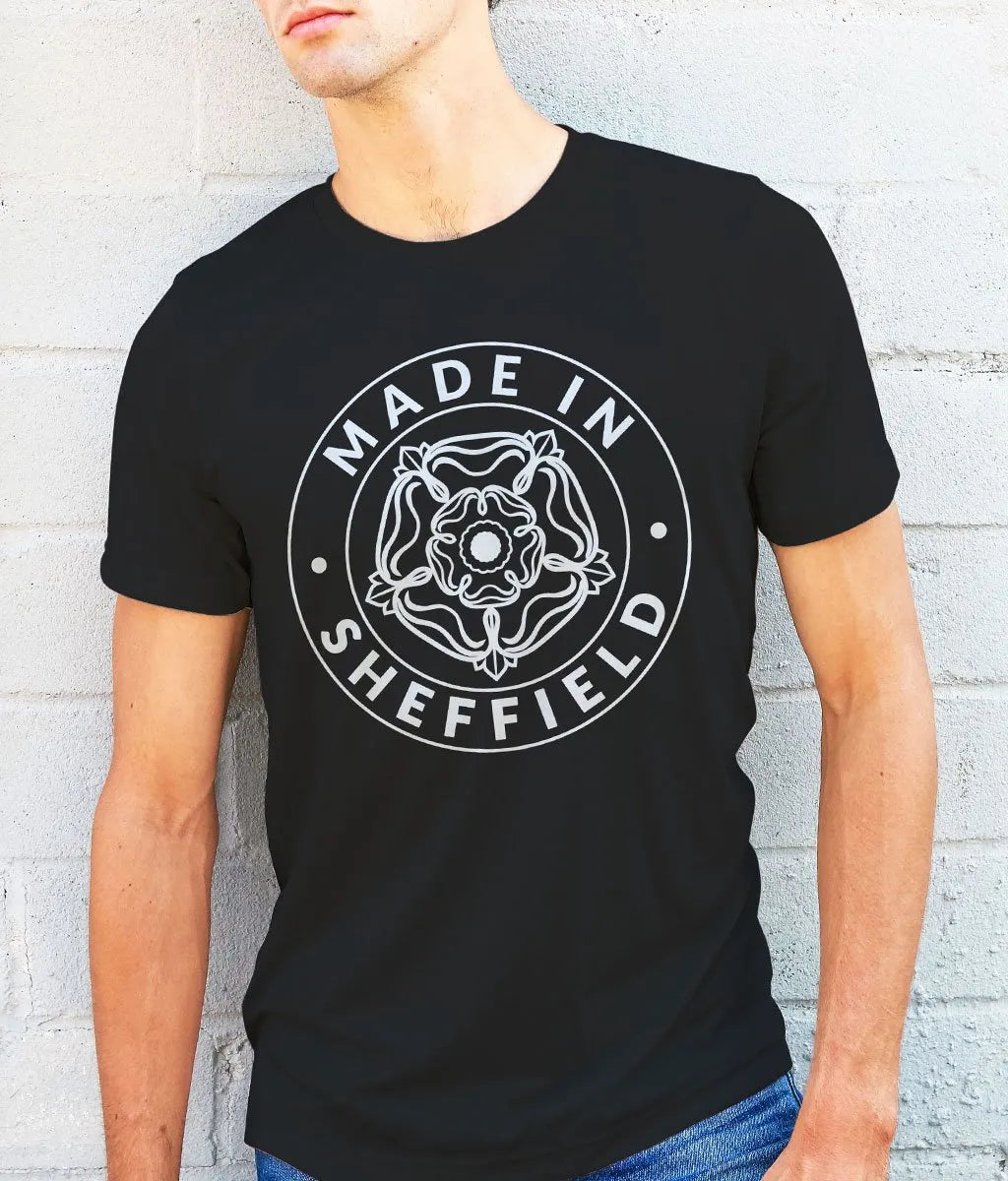 Person wearing a black t-shirt with 'Made in Sheffield' design on a white background