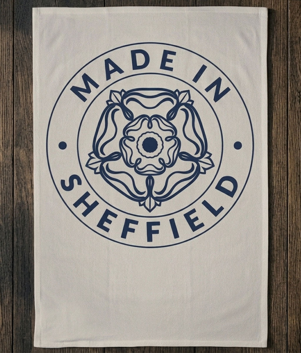 Tea Towel with 'Made in Sheffield' design on a wooden surface