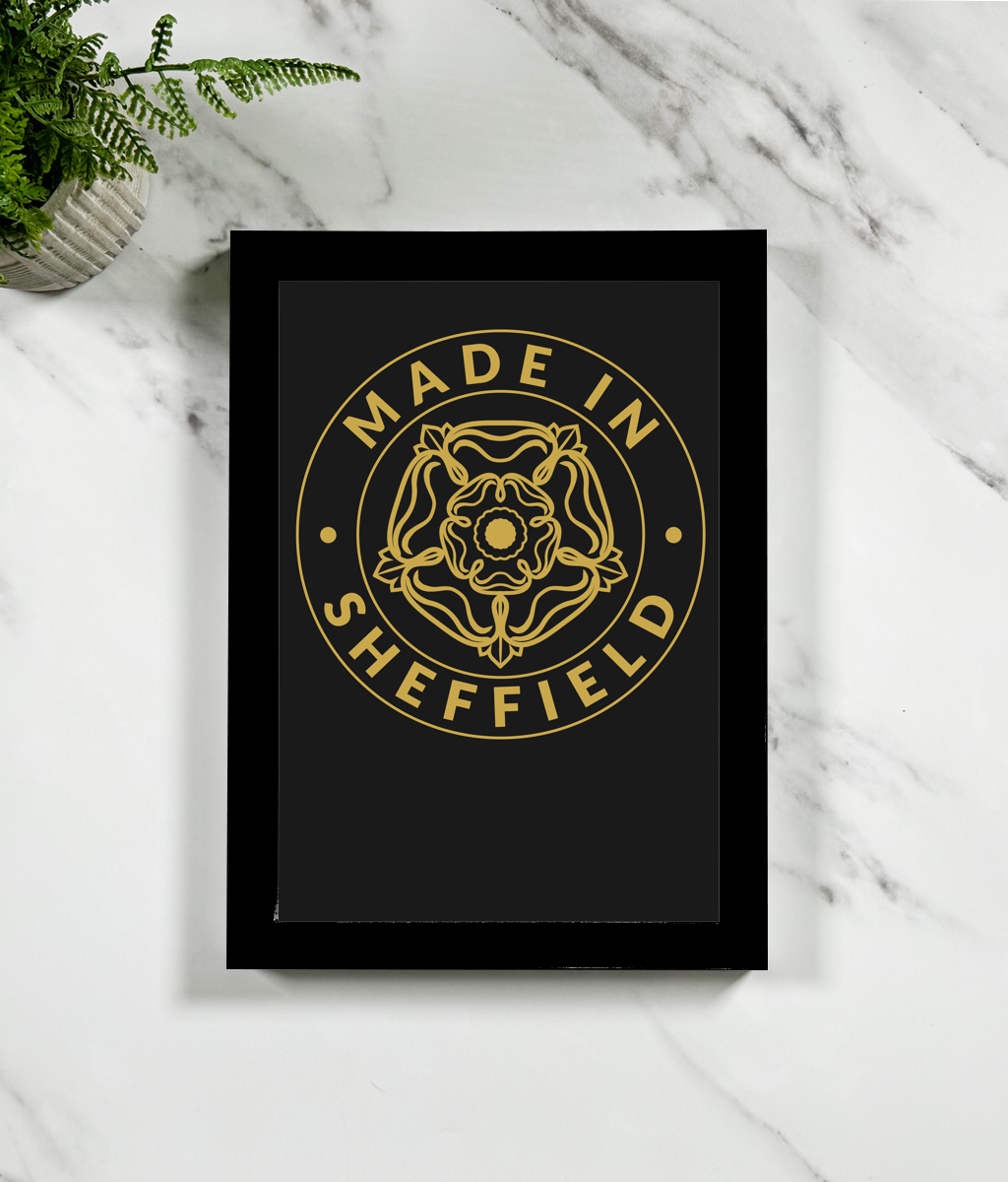 Framed artwork with 'Made in Sheffield' design on a marble surface.