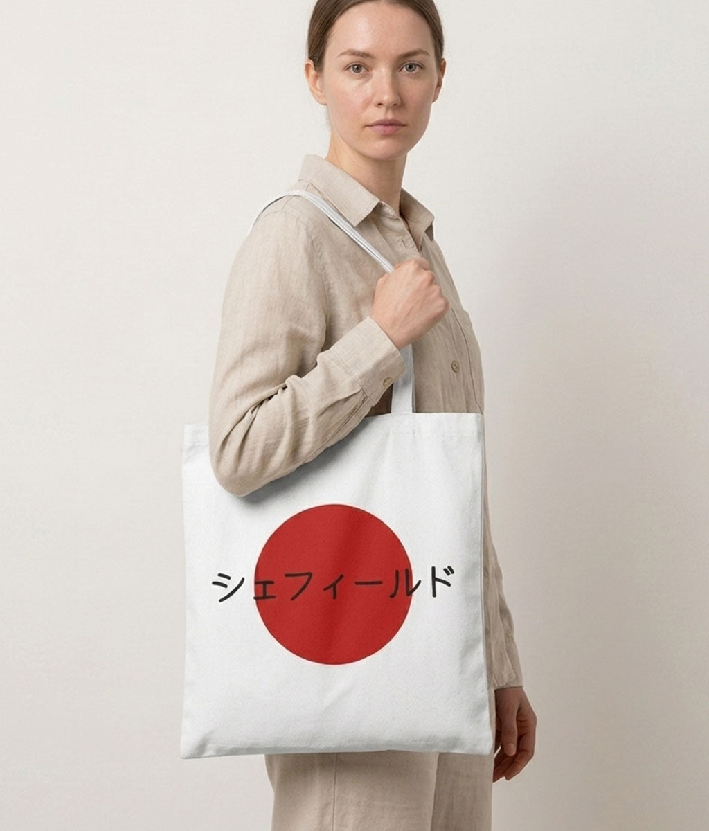 Person holding a tote bag with a red circle and text on a plain background